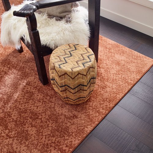red rug under the coffee table in living room area on Fort Morgan, CO area by Specialty Shoppe Floors